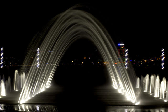 Fountain jets creating a curved water display.